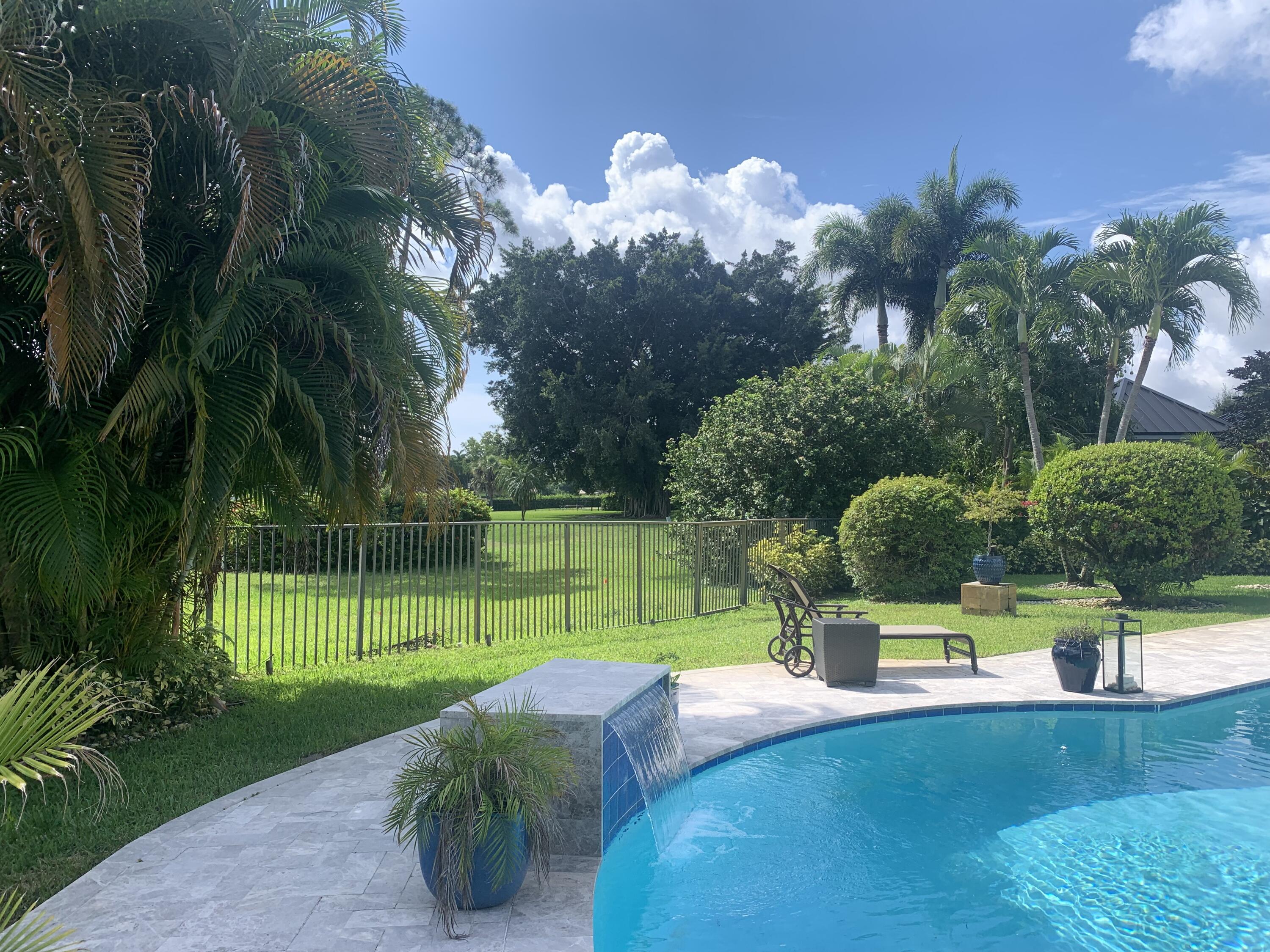 355 Oakview Drive Delray Beach, FL 33445 - Photo 91 of 92 a view of a garden with a slide and a lake view