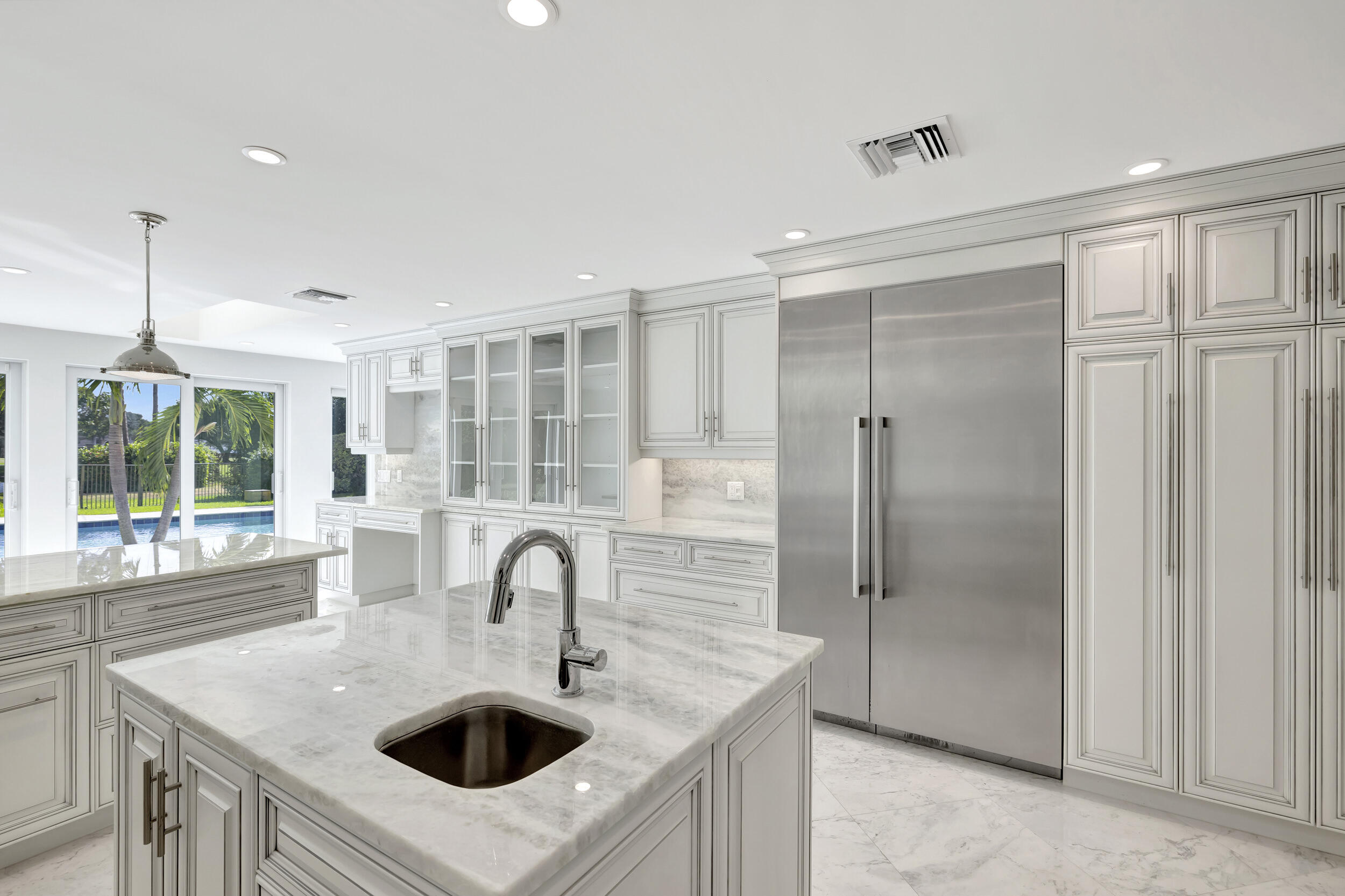 355 Oakview Drive Delray Beach, FL 33445 - Photo 10 of 92 a kitchen with kitchen island a sink appliances and a large window