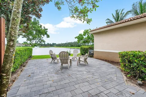 a view of a lake with a table and chair in the patio