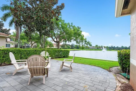a view of a chair and table in the garden and lake view