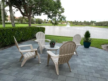 a patio table and chairs with the view of lake view
