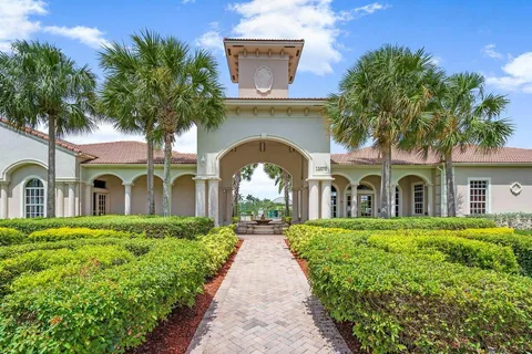a front view of a house with a garden