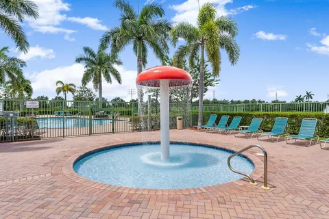 a view of a swimming pool with a table and chairs