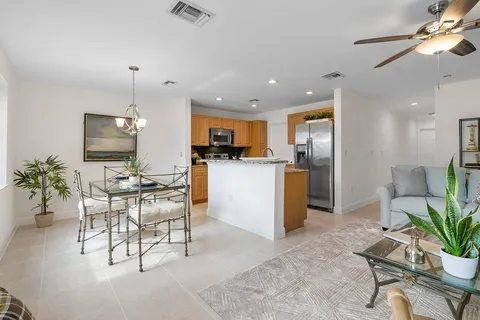a kitchen with a refrigerator and a dining table