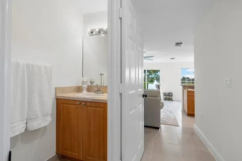 a en suite bathroom with a granite countertop sink and a mirror