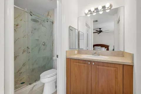 a bathroom with a sink toilet and shower