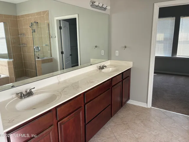 a bathroom with a double vanity sink and mirror
