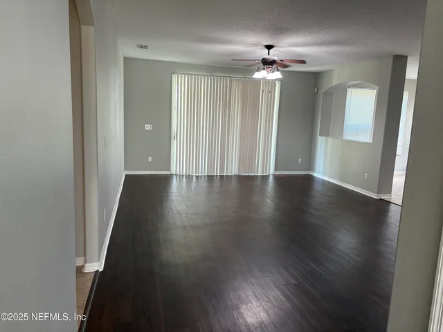 wooden floor in an empty room with a mirror