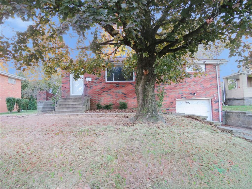 214 Erwin Place McKees Rocks, PA 15136 - Photo 1 of 25 a backyard of a house with a tree