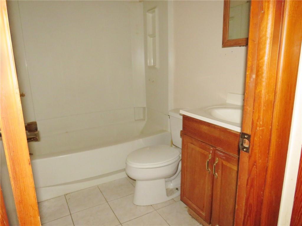 214 Erwin Place McKees Rocks, PA 15136 - Photo 12 of 25 a bathroom with a toilet and a shower curtain