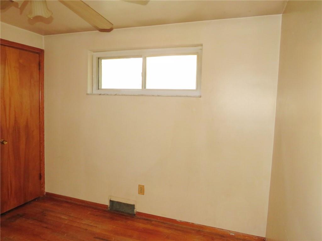 214 Erwin Place McKees Rocks, PA 15136 - Photo 19 of 25 an empty room with wooden floor and window