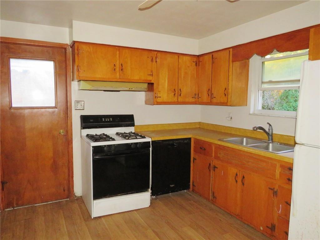 214 Erwin Place McKees Rocks, PA 15136 - Photo 23 of 25 a kitchen with stainless steel appliances granite countertop a stove a sink and a refrigerator