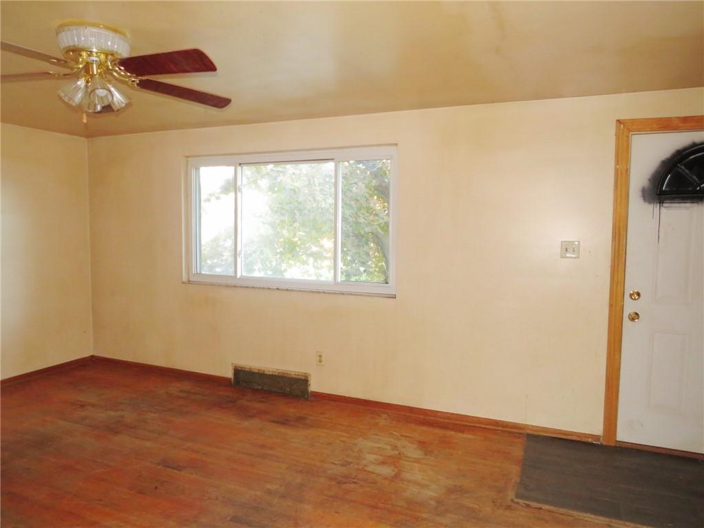 214 Erwin Place McKees Rocks, PA 15136 - Photo 8 of 25 an empty room with a window and a ceiling fan