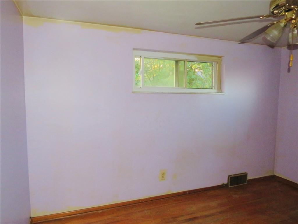 214 Erwin Place McKees Rocks, PA 15136 - Photo 10 of 25 a view of an empty room with a window and wooden floor