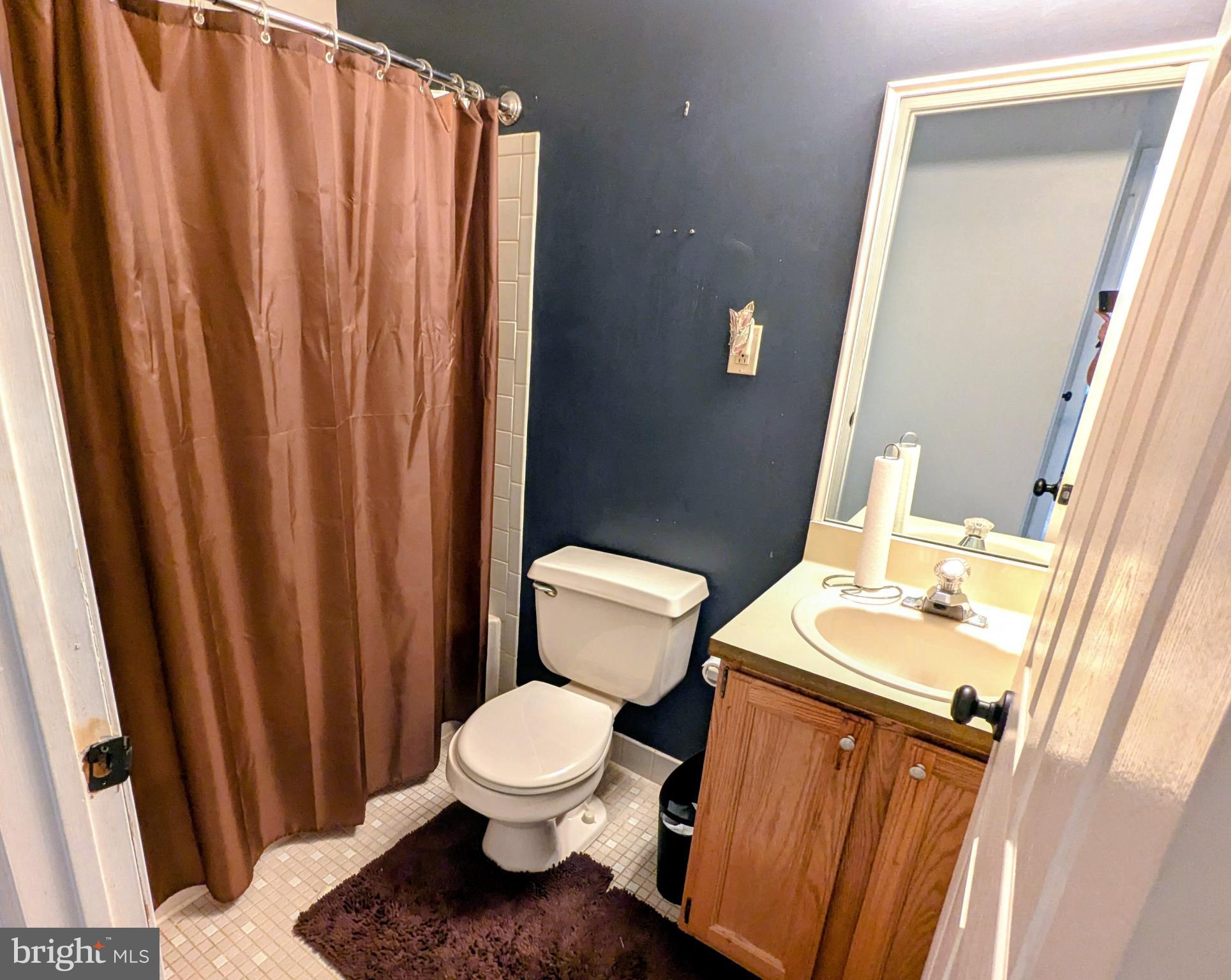 409 Silvia Street Ewing, NJ 08628 - Photo 15 of 16 a white toilet sitting next to a bathroom sink