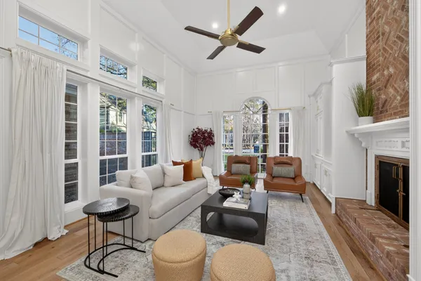 a kitchen with stainless steel appliances granite countertop a sink a stove a refrigerator and white cabinets with wooden floor