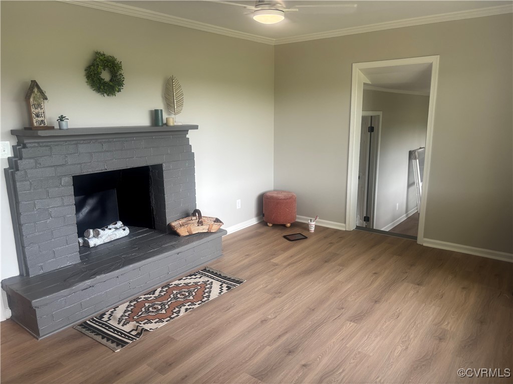 Living room featuring wood finished floors, crown