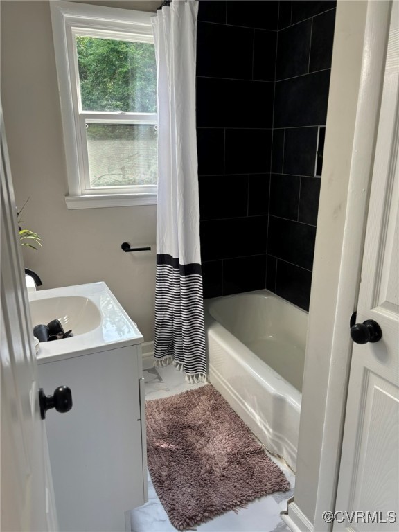 Bathroom with vanity, marble look tile flooring, a