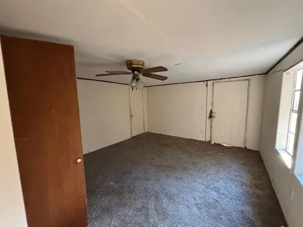 an empty room with windows and closet