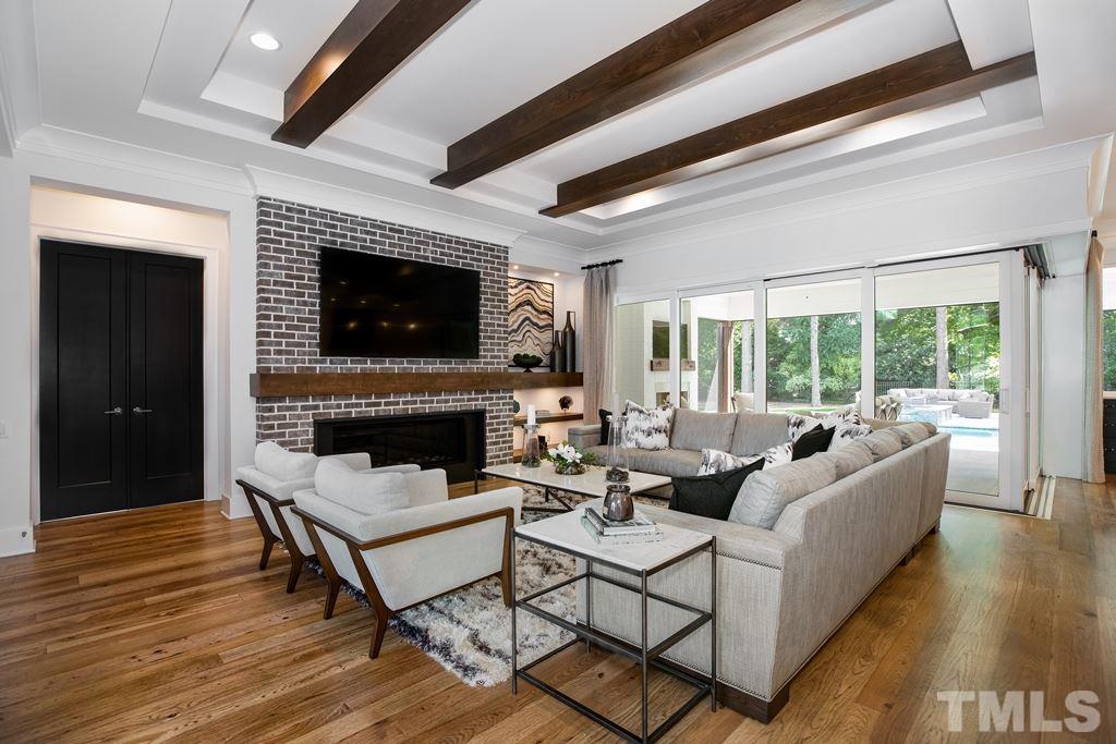 405 Vernon Terrace Raleigh, NC 27609 - Photo 2 of 26 a living room with furniture a fireplace and a flat screen tv