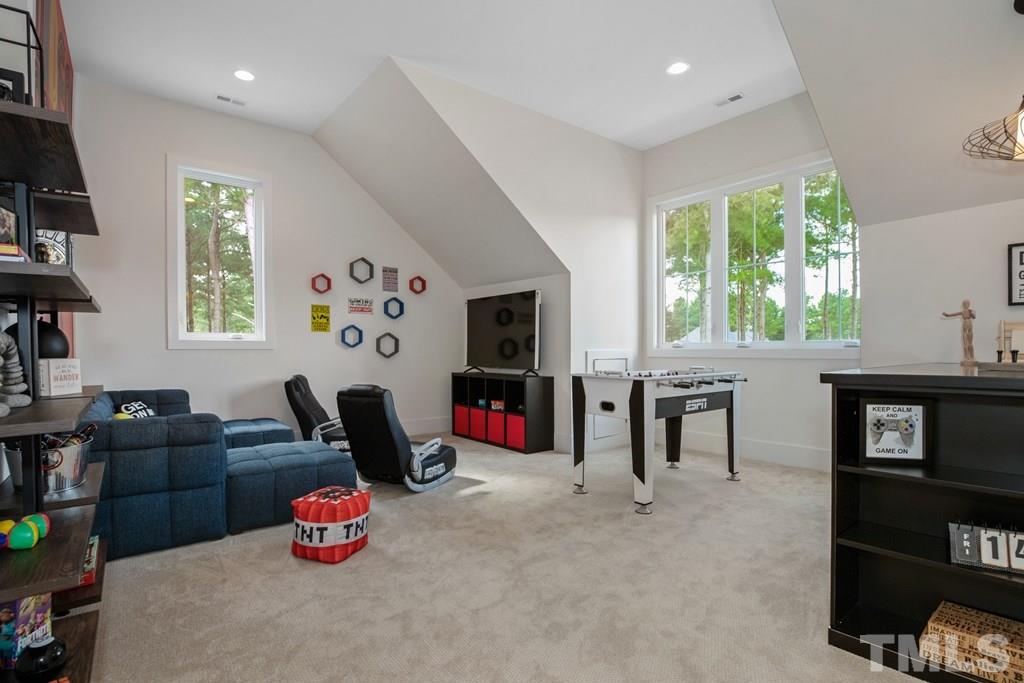 405 Vernon Terrace Raleigh, NC 27609 - Photo 24 of 26 a living room with furniture a window and flat screen tv