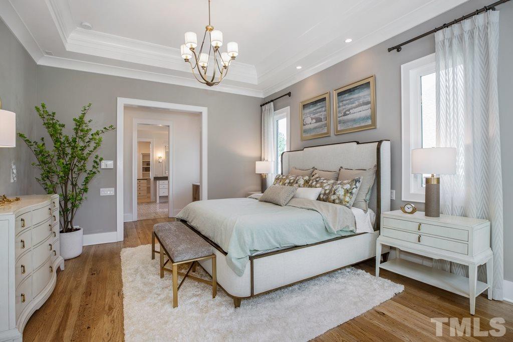 405 Vernon Terrace Raleigh, NC 27609 - Photo 10 of 26 a bedroom with a large bed and a chandelier