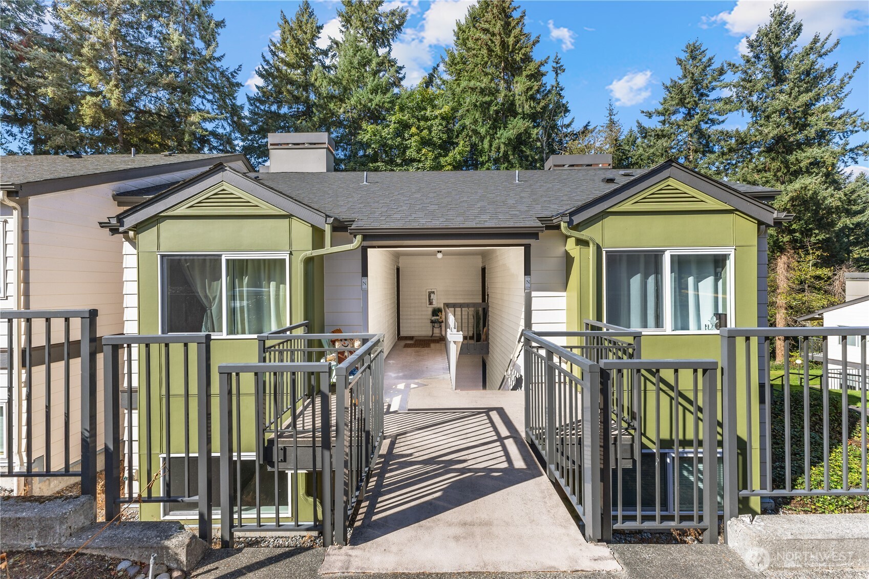 31500 33rd Place Southwest, Unit N103 Federal Way, WA 98023 - Photo 16 of 25 a view of a house with large windows and a small yard