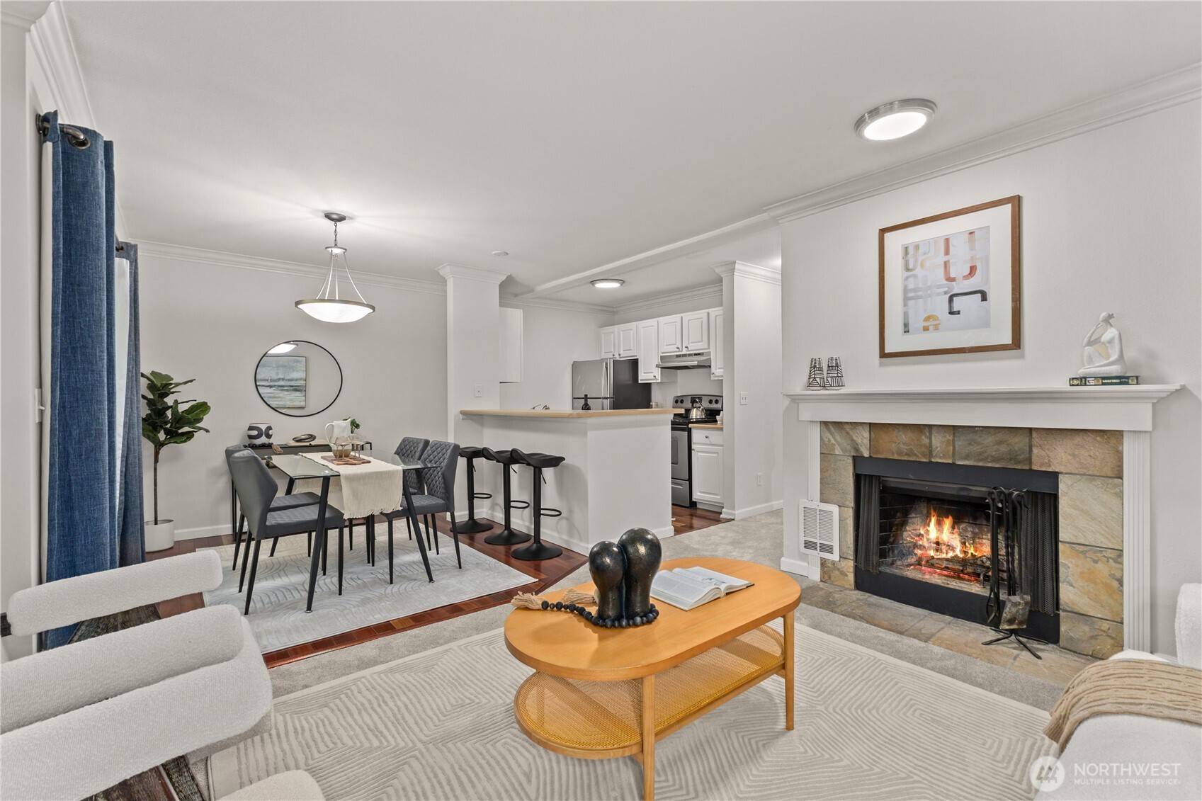 31500 33rd Place Southwest, Unit N103 Federal Way, WA 98023 - Photo 4 of 25 a living room with furniture a fireplace and a wall painting