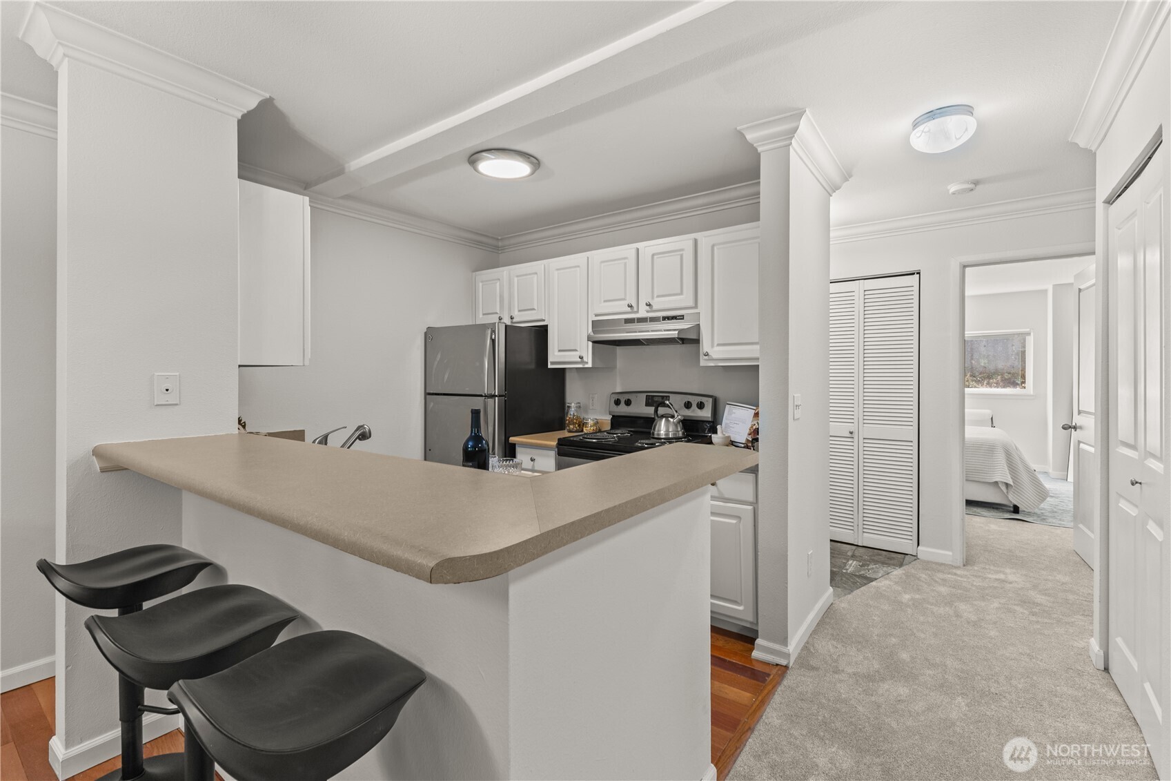 31500 33rd Place Southwest, Unit N103 Federal Way, WA 98023 - Photo 7 of 25 a kitchen that has a cabinets and a stove