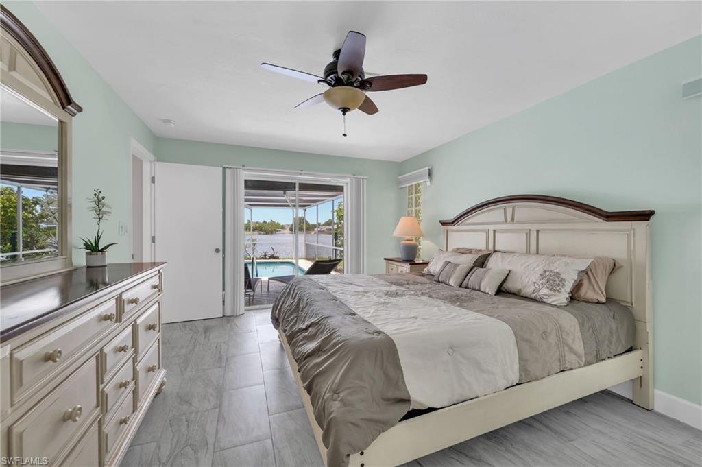 3065 50th Lane Southwest Naples, FL 34116 - Photo 14 of 31 a bedroom with a large bed and a window