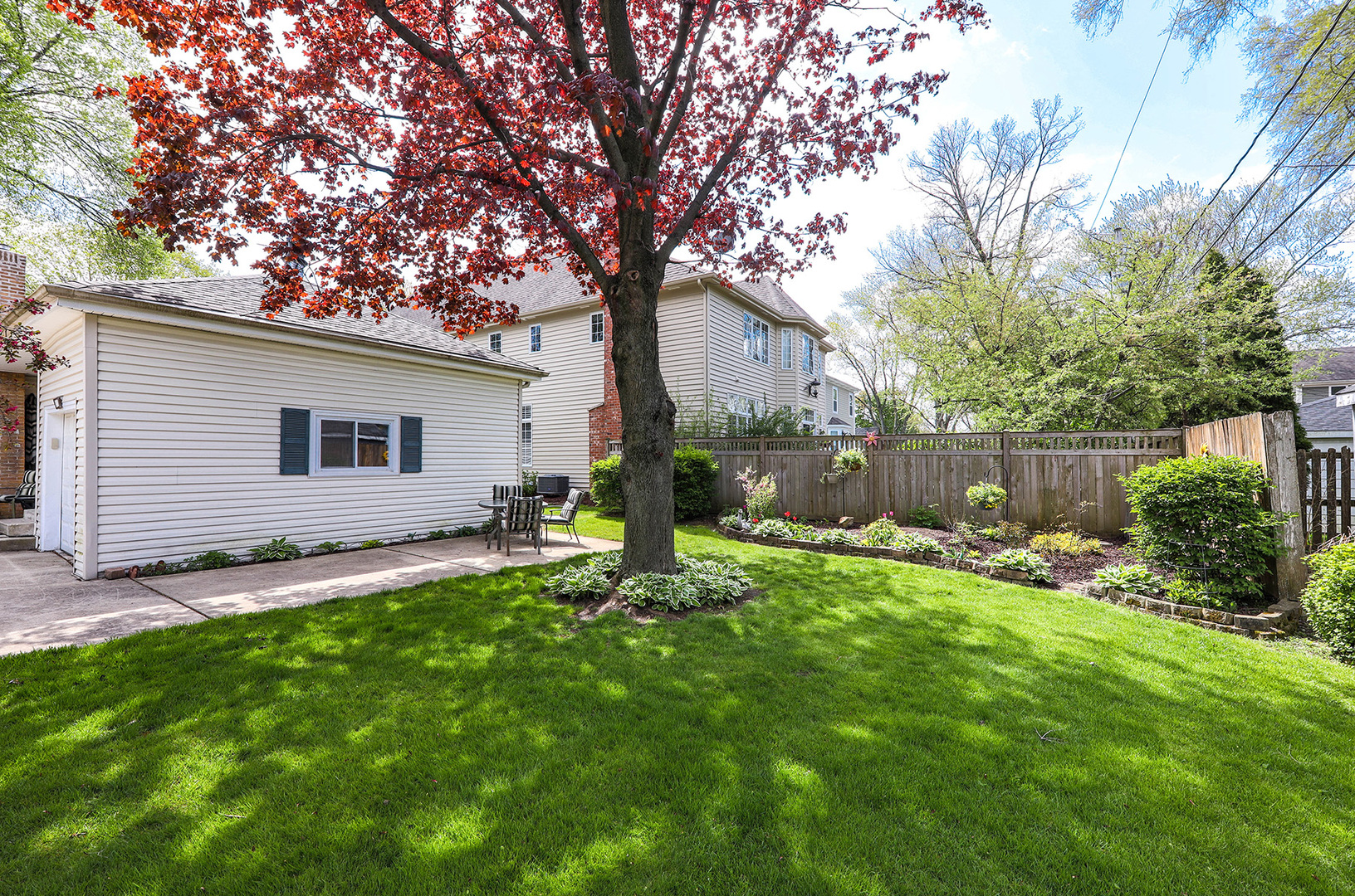 110 West 12th Avenue Naperville, IL 60563 - Photo 19 of 20 a backyard of a house with table and chairs