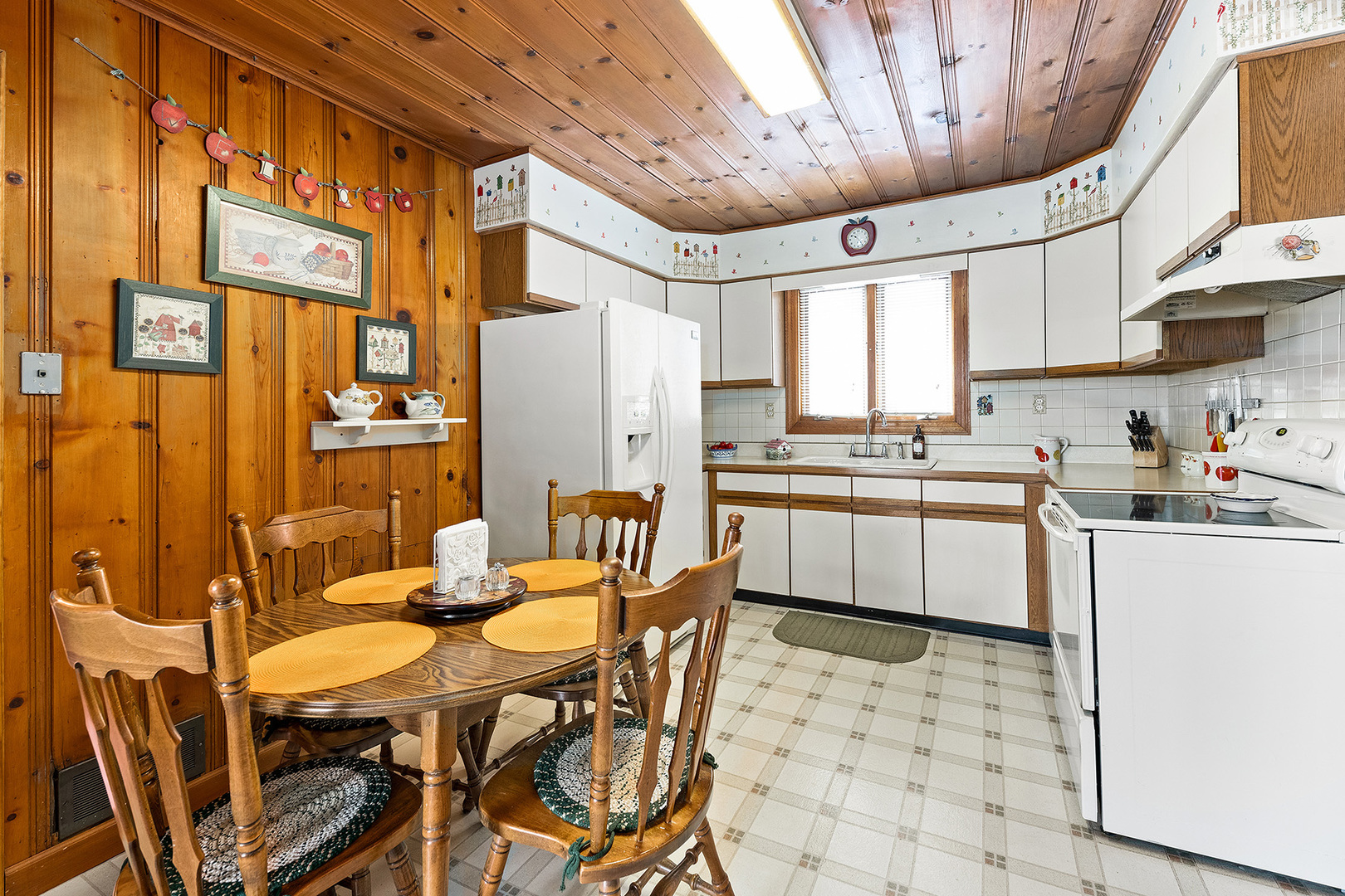 110 West 12th Avenue Naperville, IL 60563 - Photo 6 of 20 a kitchen with stainless steel appliances a table chairs and a refrigerator