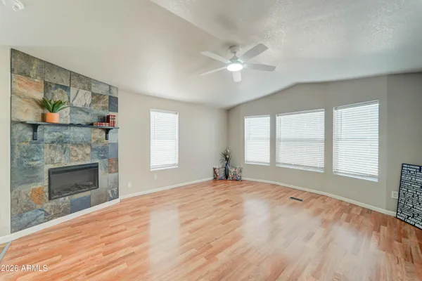 a view of empty room with a fireplace and fan