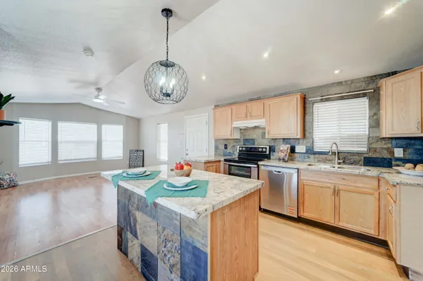 a open kitchen with stainless steel appliances granite countertop a stove and a sink