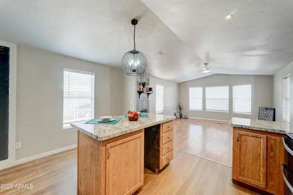 a large kitchen with kitchen island a large counter space a sink appliances and cabinets