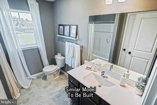 a bathroom with a sink toilet and a mirror