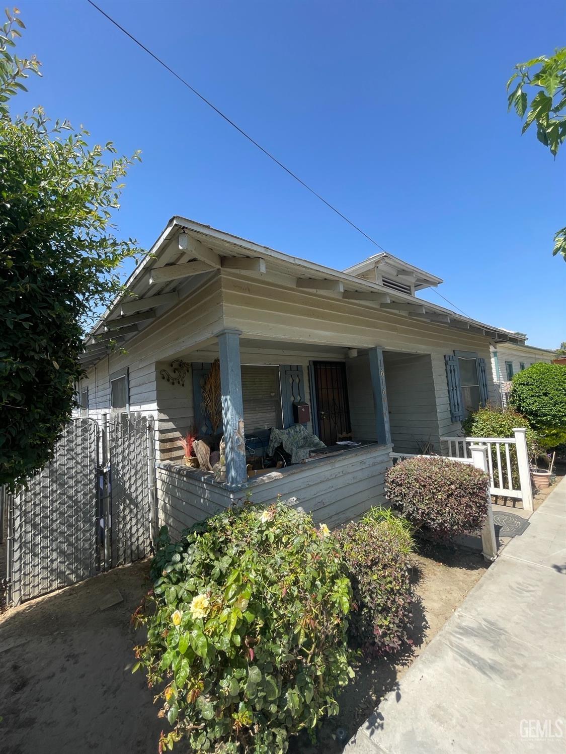 Undisclosed Address Bakersfield, CA 93304 - Photo 2 of 21 a front view of a house with a porch