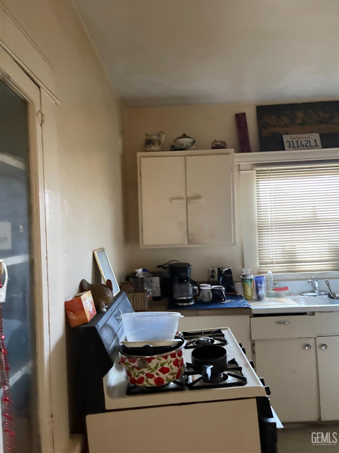 Undisclosed Address Bakersfield, CA 93304 - Photo 7 of 21 a kitchen with granite countertop a stove and a sink
