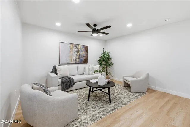 a living room with furniture and a potted plant