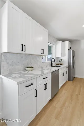 a living room with furniture potted plant and a large window
