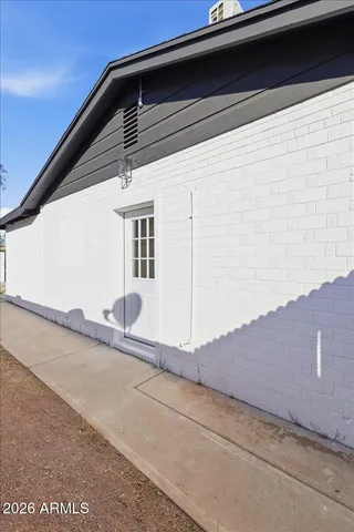 an empty room with wooden floor and ceiling fan
