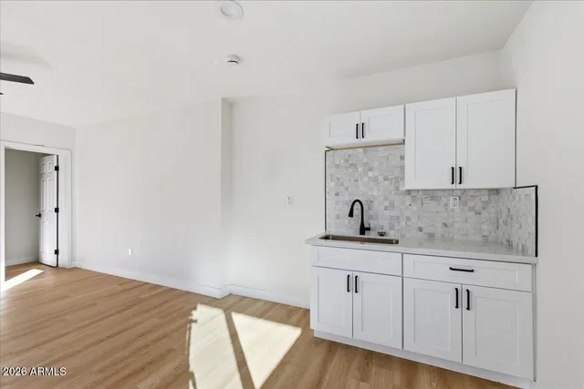 a bathroom with a tub shower and mirror