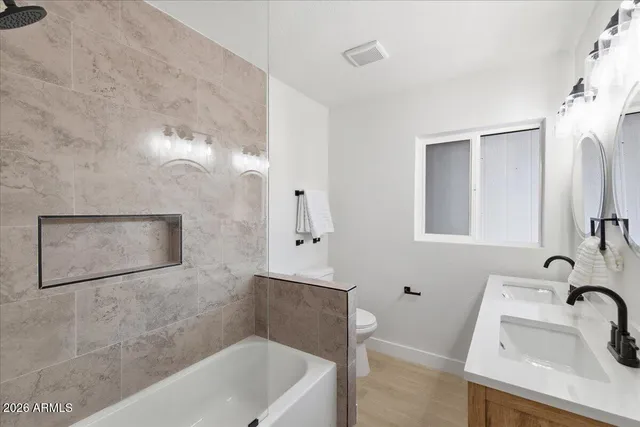 a bathroom with a toilet sink and a mirror