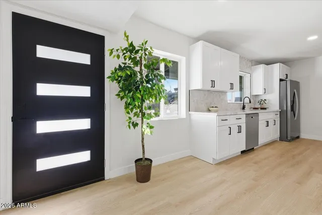 a kitchen with stainless steel appliances a refrigerator and a sink