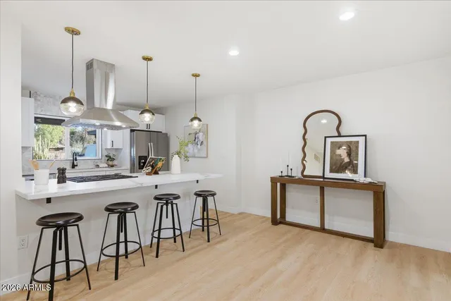 a kitchen with stainless steel appliances granite countertop a stove a sink and white cabinets