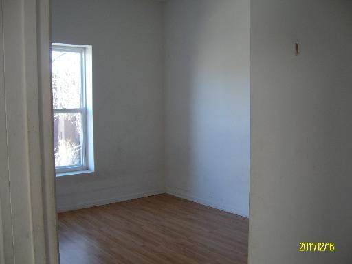 5203 South Calumet Avenue, Unit 3D Chicago, IL 60615 - Photo 8 of 8 an empty room with wooden floor and windows