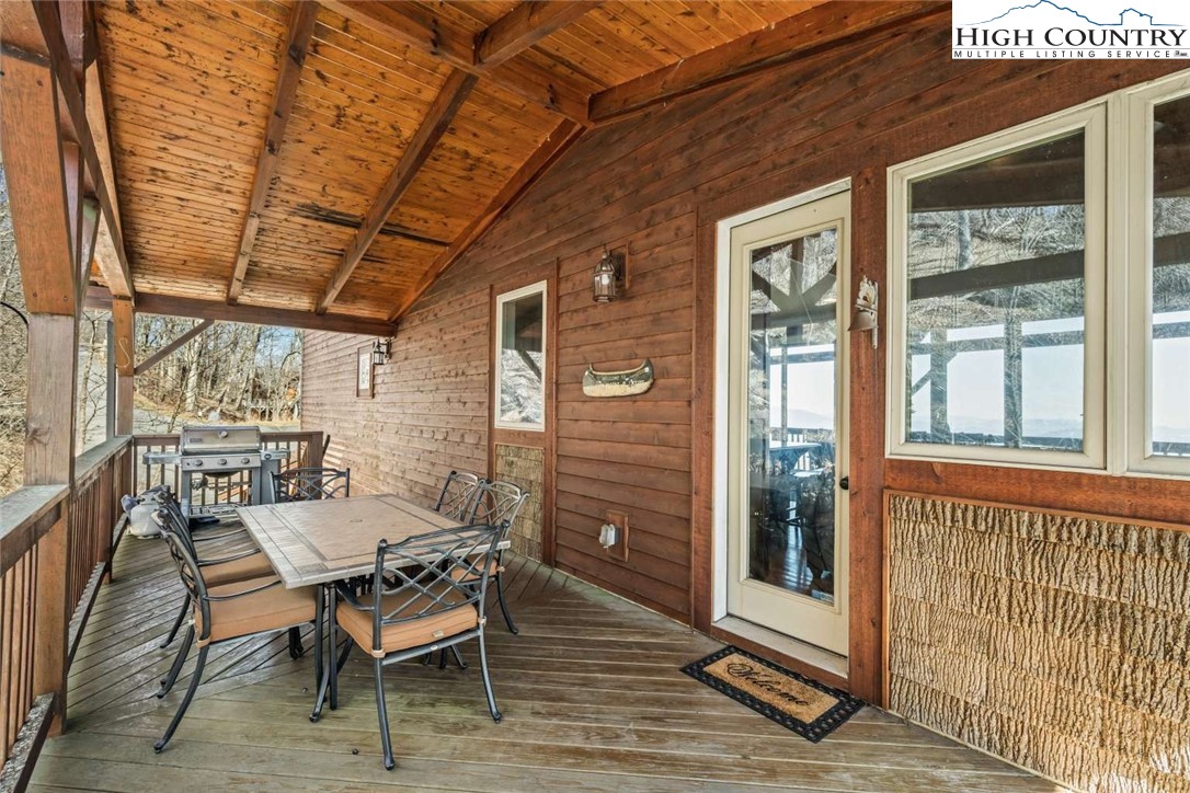 585 Stony Fork Road West Jefferson, NC 28694 - Photo 13 of 25 a balcony with furniture and wooden floor