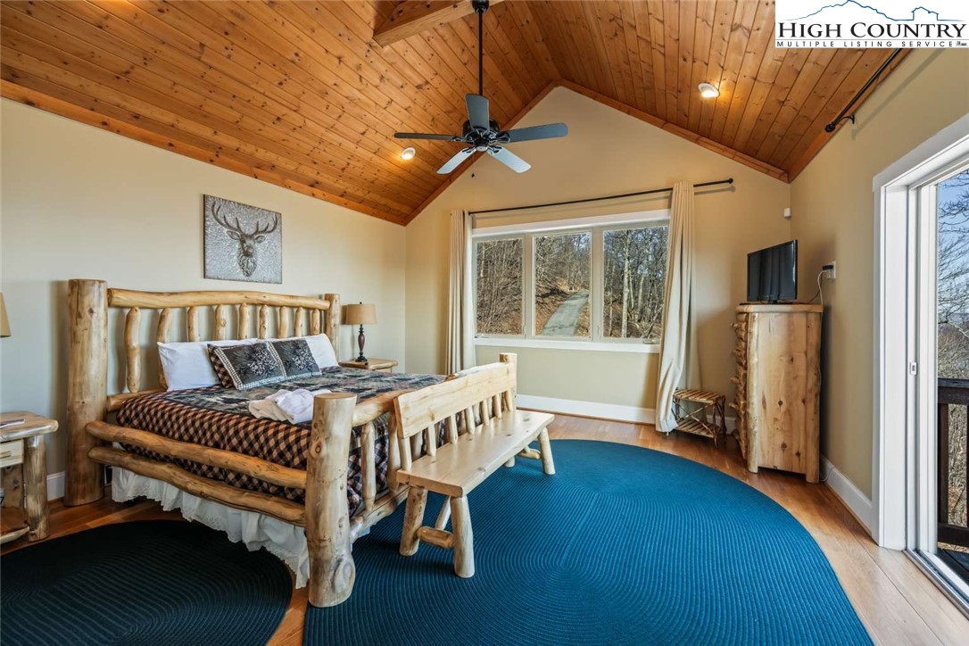 585 Stony Fork Road West Jefferson, NC 28694 - Photo 16 of 25 a bedroom with furniture and a window