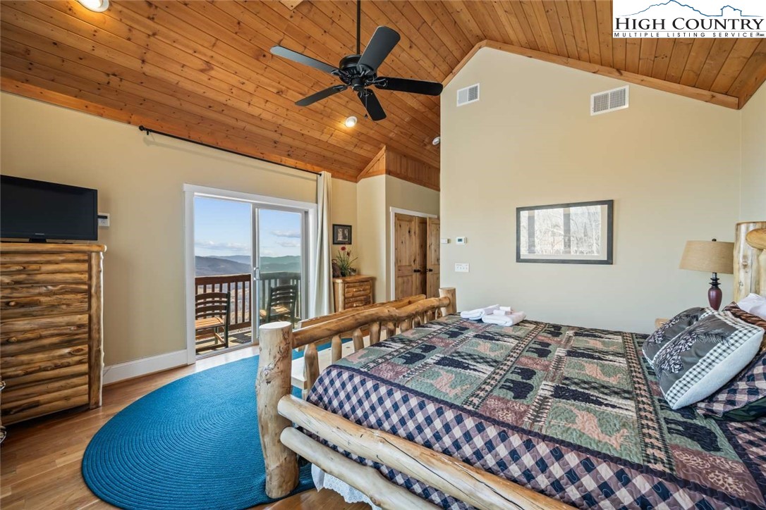 585 Stony Fork Road West Jefferson, NC 28694 - Photo 17 of 25 a bedroom with a bed and wooden floor