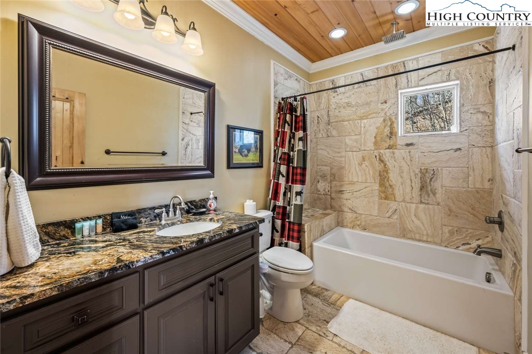 585 Stony Fork Road West Jefferson, NC 28694 - Photo 21 of 25 a bathroom with a granite countertop sink toilet and shower
